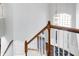 Elegant staircase with wood railing and hardwood floors at 13678 Cunningham Dr, Carmel, IN 46074