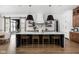 Modern kitchen with a large island, quartz countertops, and dark wood cabinets at 14028 Grannan Ln, Carmel, IN 46074