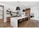 Modern kitchen with a large island, quartz countertops, and dark and light wood cabinets at 14028 Grannan Ln, Carmel, IN 46074