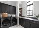 Modern laundry room with washer, dryer, and stylish cabinetry at 14028 Grannan Ln, Carmel, IN 46074