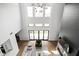 Open living room with high ceilings, a fireplace, and lots of natural light at 14028 Grannan Ln, Carmel, IN 46074