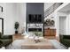 Modern living room featuring a statement fireplace and built-in shelving at 14028 Grannan Ln, Carmel, IN 46074