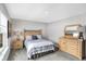 Bedroom with wood dresser, large window, and striped bedding at 1574 Mairn Ave, Carmel, IN 46032