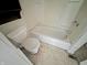 Bathroom with a dated toilet, bathtub, and vanity showing signs of wear and is in need of repairs at 1610 Hoefgen St, Indianapolis, IN 46203