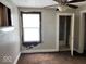 A bedroom with brown carpet, a window, and a doorway to a bathroom at 1610 Hoefgen St, Indianapolis, IN 46203