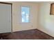 Empty bedroom with light walls, brown carpet, natural light, and unpainted window frames at 1610 Hoefgen St, Indianapolis, IN 46203