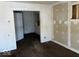 Bedroom with brown carpet, damaged walls, and open door to another room at 1610 Hoefgen St, Indianapolis, IN 46203