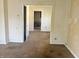 Hallway with kitchen view, light from the windows, brown carpet, and white walls at 1610 Hoefgen St, Indianapolis, IN 46203