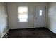 A living room with a window and a white door at 1610 Hoefgen St, Indianapolis, IN 46203