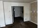Living room with damaged walls and floors, needs renovation at 1610 Hoefgen St, Indianapolis, IN 46203