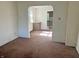 Arched doorway to the kitchen, light from the windows, brown carpet, and white walls at 1610 Hoefgen St, Indianapolis, IN 46203