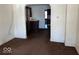 Simple living room with brown carpet and archway to kitchen at 1610 Hoefgen St, Indianapolis, IN 46203