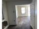 Living room with brown carpet and door to another room at 1610 Hoefgen St, Indianapolis, IN 46203