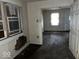 View of a living room with damaged walls and floors. Needs renovation at 1610 Hoefgen St, Indianapolis, IN 46203