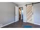 Bedroom with barn door and access to bathroom at 1654 Iowa St, Indianapolis, IN 46203