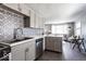 Open concept kitchen with gray cabinets and stainless steel appliances at 1654 Iowa St, Indianapolis, IN 46203