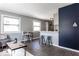 Open living area with gray walls, wood floors, and modern furniture at 1654 Iowa St, Indianapolis, IN 46203