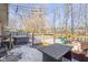 Deck with hot tub, string lights, and backyard view with a playground at 18 Round Hill Ct, Danville, IN 46122