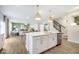 Open concept kitchen, island, and Gathering room with hardwood floors at 18932 Seaforth Way, Westfield, IN 46074