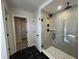 This bathroom features a walk-in shower with black fixtures and a glass door at 19962 Stone Side Ct, Westfield, IN 46074