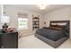 Well-lit bedroom with a comfortable bed, floating shelves, and a neutral color scheme at 19962 Stone Side Ct, Westfield, IN 46074