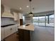 Bright kitchen features an island, stainless appliances, subway tile backsplash, and ample natural light from large sliding glass doors at 19962 Stone Side Ct, Westfield, IN 46074