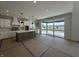 Modern kitchen with a spacious island, white cabinets, stainless steel appliances, and sliding glass door at 19962 Stone Side Ct, Westfield, IN 46074