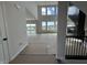 Open-concept living room with tall windows, sliding glass door, a fireplace, and modern staircase at 19962 Stone Side Ct, Westfield, IN 46074