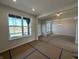 Inviting living room with a large window, white trim, open entryway, and chandelier at 19962 Stone Side Ct, Westfield, IN 46074