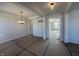 Spacious living room with white walls and trim, modern chandelier, and open floor plan at 19962 Stone Side Ct, Westfield, IN 46074