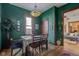 Green dining room features a wooden table and view into the living room at 2006 E 10Th St, Indianapolis, IN 46201