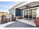 Covered back porch featuring comfortable seating, a ceiling fan, and sliding glass doors for indoor/outdoor living at 20188 Hampton Park Dr, Westfield, IN 46074