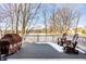 Backyard deck includes chairs, grill, and snowy view at 20188 Hampton Park Dr, Westfield, IN 46074