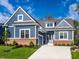 Beautiful home with blue siding, brick foundation, concrete driveway and manicured lawn at 20188 Hampton Park Dr, Westfield, IN 46074