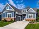 Home boasts blue siding, brick accents, an attached garage and a pristine lawn at 20188 Hampton Park Dr, Westfield, IN 46074
