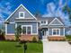 Charming two-story home featuring blue siding, brick accents, and a well-manicured front yard at 20188 Hampton Park Dr, Westfield, IN 46074