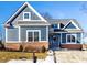 Charming blue two-story home with brick foundation, manicured lawn, and a welcoming front entrance at 20188 Hampton Park Dr, Westfield, IN 46074