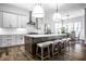 Modern kitchen featuring an island with seating, stainless steel appliances, and stylish pendant lighting at 20188 Hampton Park Dr, Westfield, IN 46074