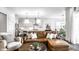 Bright living room with a leather sofa, an open kitchen, and modern pendant lighting at 20188 Hampton Park Dr, Westfield, IN 46074