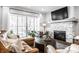 Cozy living room featuring a stone fireplace, a sectional sofa, and natural light from the sliding glass doors at 20188 Hampton Park Dr, Westfield, IN 46074