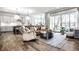 Open-concept living space with a plush leather sofa, a bright kitchen, and natural light from the sliding glass doors at 20188 Hampton Park Dr, Westfield, IN 46074