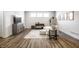 Cozy, minimalist living room with luxury vinyl plank flooring, plush seating, and neutral decor at 20188 Hampton Park Dr, Westfield, IN 46074