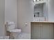 Clean bathroom with toilet, vanity, and shower at 2450 Carrollton Ave, Indianapolis, IN 46205