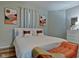 Spacious bedroom with king-size bed, orange chair, and modern art at 2450 Carrollton Ave, Indianapolis, IN 46205
