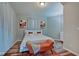 Spacious bedroom with king-size bed, orange bench, and abstract art at 2450 Carrollton Ave, Indianapolis, IN 46205