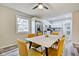 Dining area with a light gray table and mustard yellow chairs at 2450 Carrollton Ave, Indianapolis, IN 46205