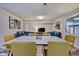 Dining room with a large table, yellow chairs, and view into living room at 2450 Carrollton Ave, Indianapolis, IN 46205