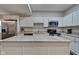 Modern kitchen with stainless steel appliances and white cabinets at 2450 Carrollton Ave, Indianapolis, IN 46205