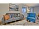 Gray sofa with pillows and a blue armchair in a living room at 2450 Carrollton Ave, Indianapolis, IN 46205