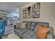 Gray sofa with pillows in a living room, kitchen in the background at 2450 Carrollton Ave, Indianapolis, IN 46205